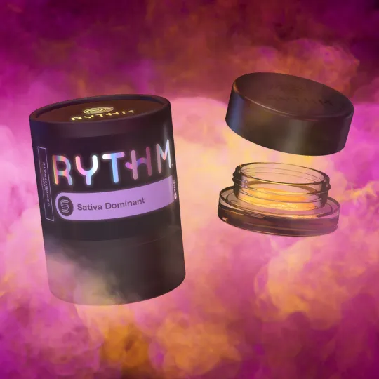 rythm concentrate containers floating in pink and yellow tinted smoke