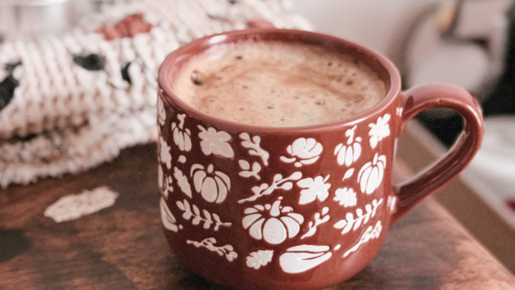 Cannabis pumpkin spice latte in a white mug with whipped cream and cinnamon on top.