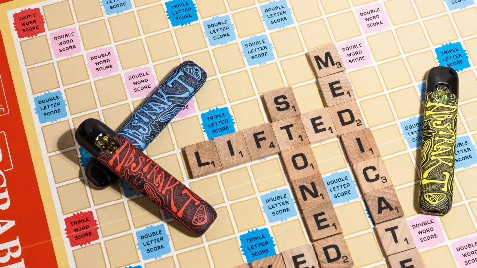 Skip the Smoke: Discreet Cannabis for Family Gatherings 1 Vape pens on Scrabble board