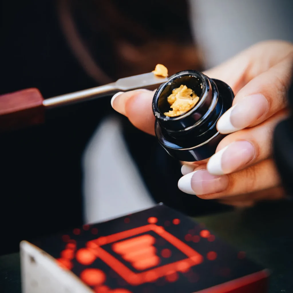 Person holding cannabis concentrate container