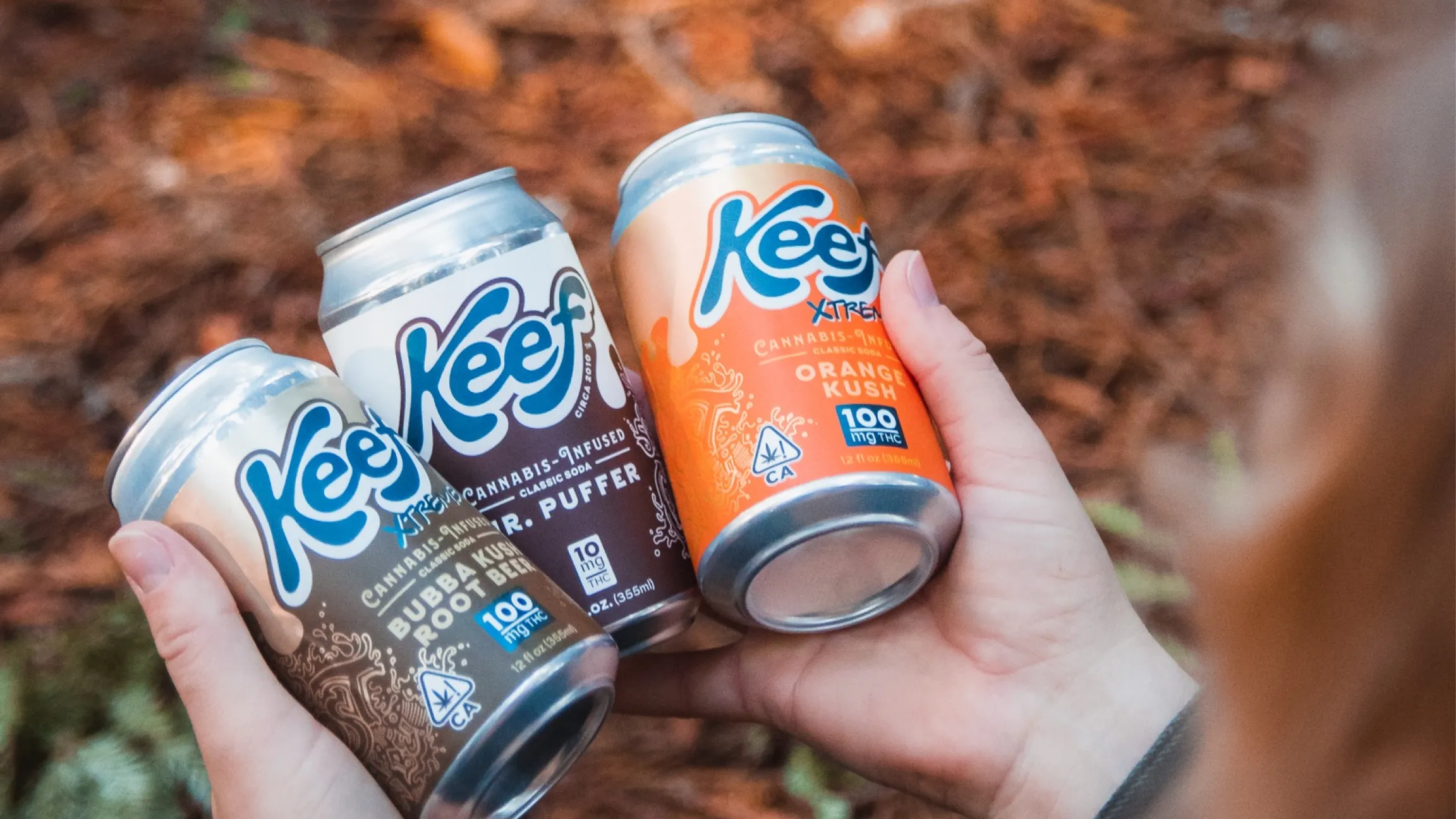 keef cola cans in hand